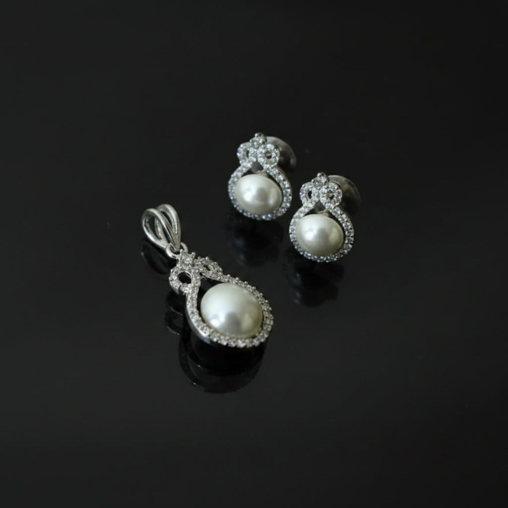 Pearl earrings with a 'Saheli' tag on a dark background