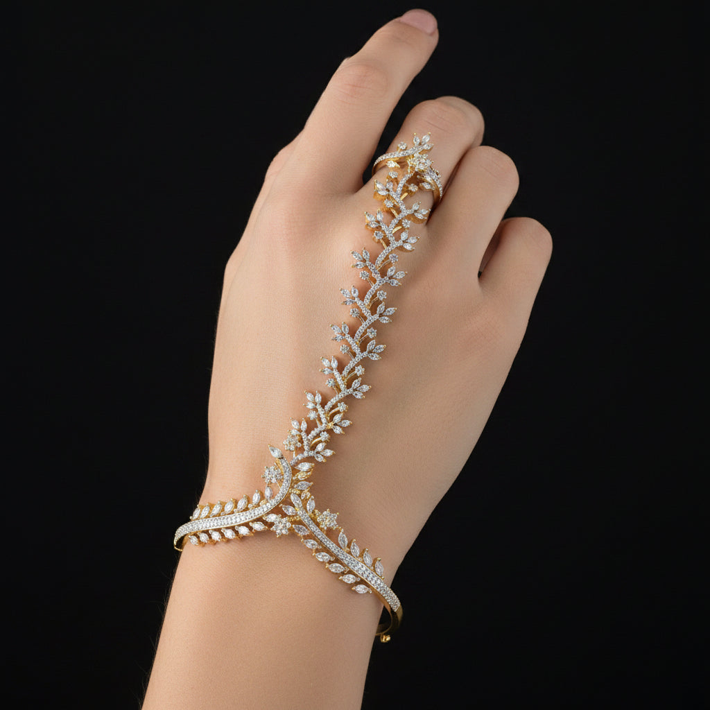 A gold-toned jewelry stand or display stand with leaf and vine motifs, embellished with clear rhinestones, set against a solid blue background.