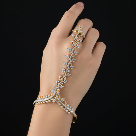 A gold-toned jewelry stand or display stand with leaf and vine motifs, embellished with clear rhinestones, set against a solid blue background.