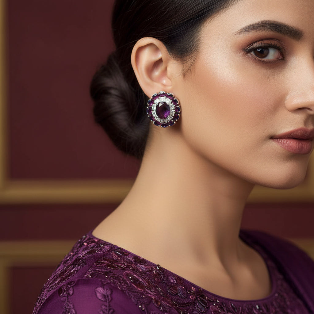 Pair of earrings with gemstones on a red background