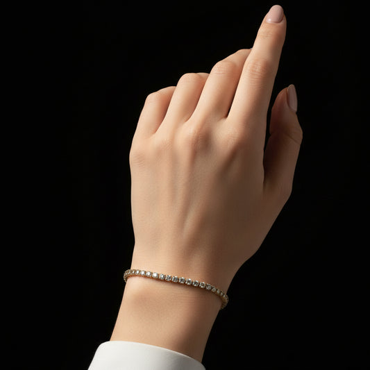 Gold bracelet with clear stones on a black background