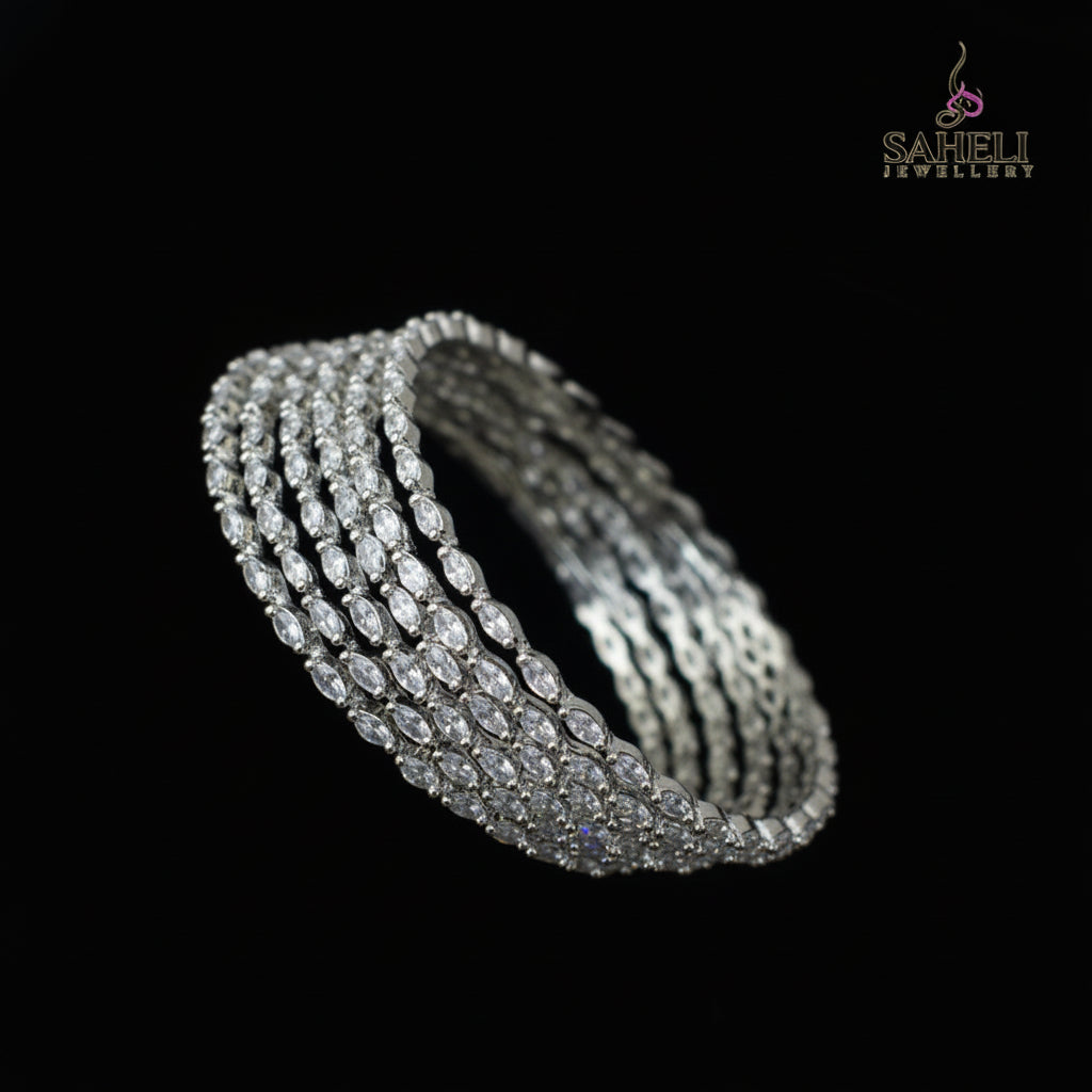 Set of diamond bangles on a black stand with a dark background