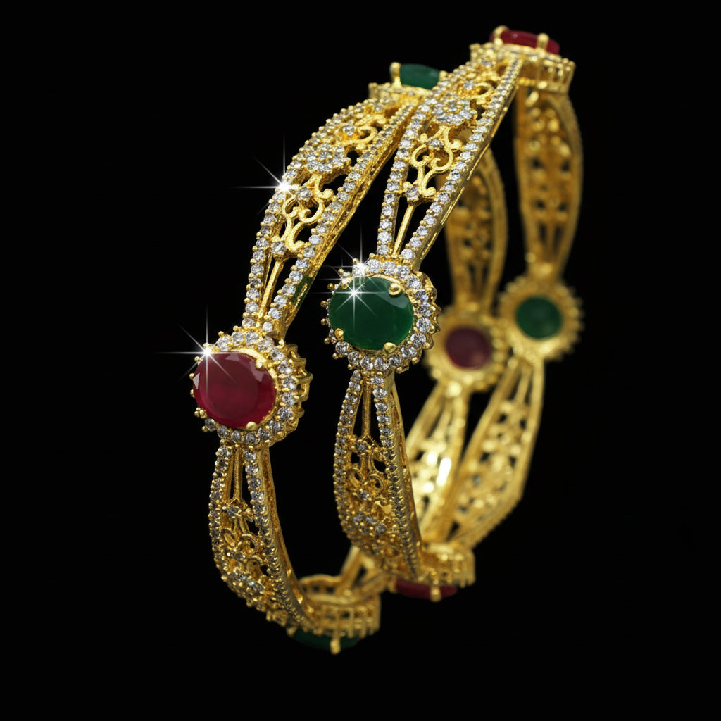 Gold bangles with gemstones on a dark background, featuring the brand 'Saheli'.