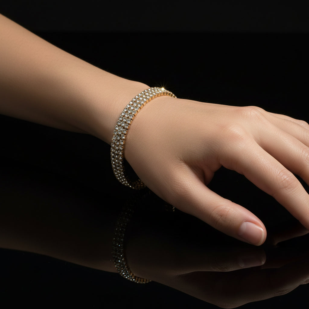 Gold bracelet with clear stones on a black background