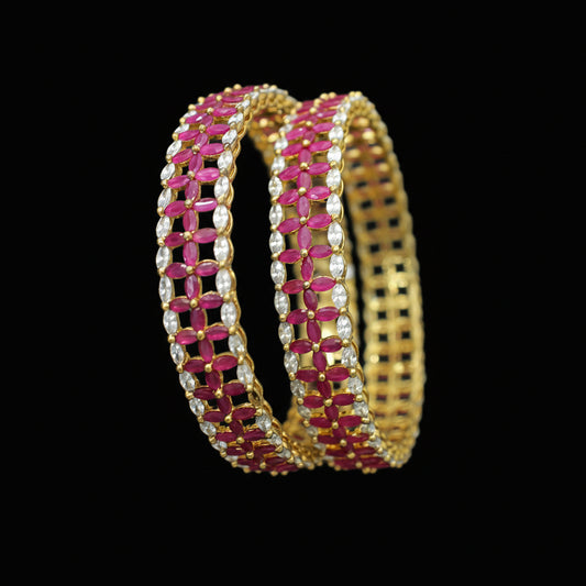 Gold and pink bangles on a black background with 'SAHELII' branding.