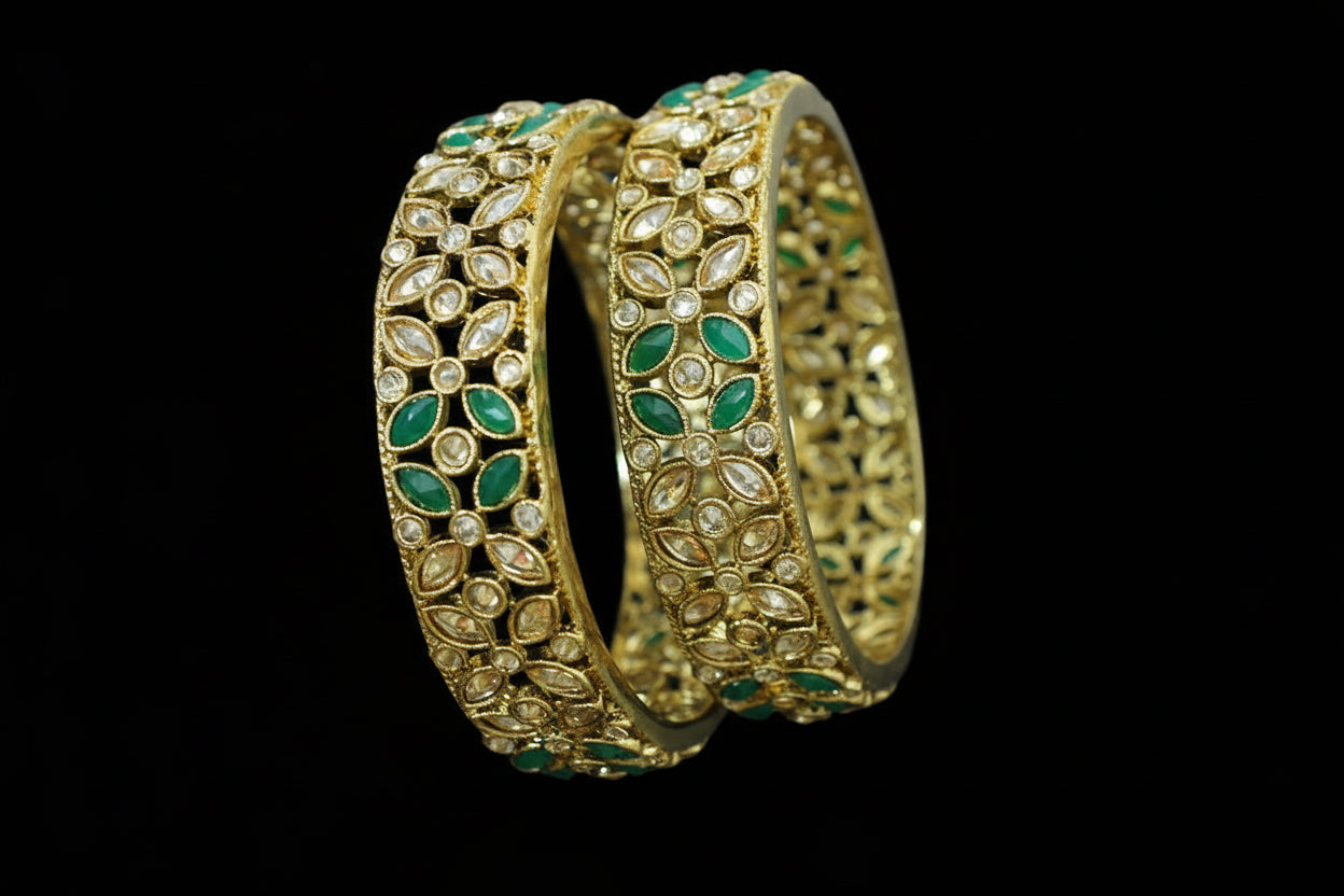 Gold and green jewelry set with 'SAHELI' branding on a gray background