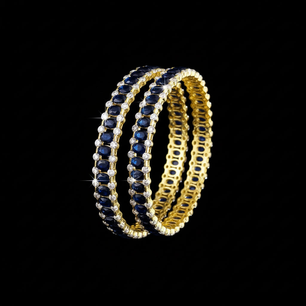 Gold and black bangles with 'Saheli' branding on a gray background
