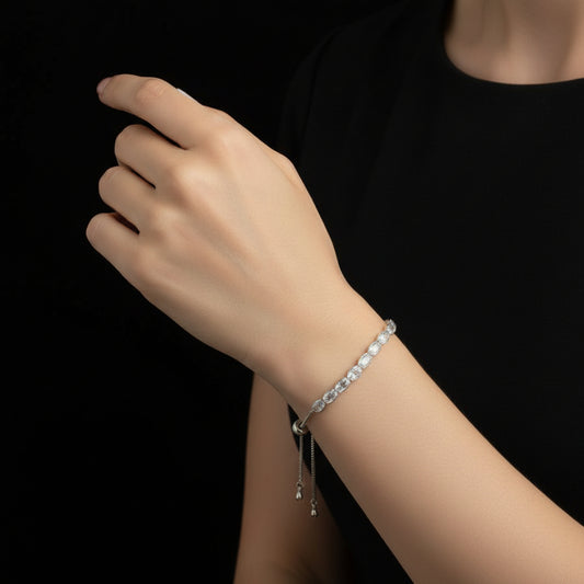 Silver bracelet with clear stones on a dark background