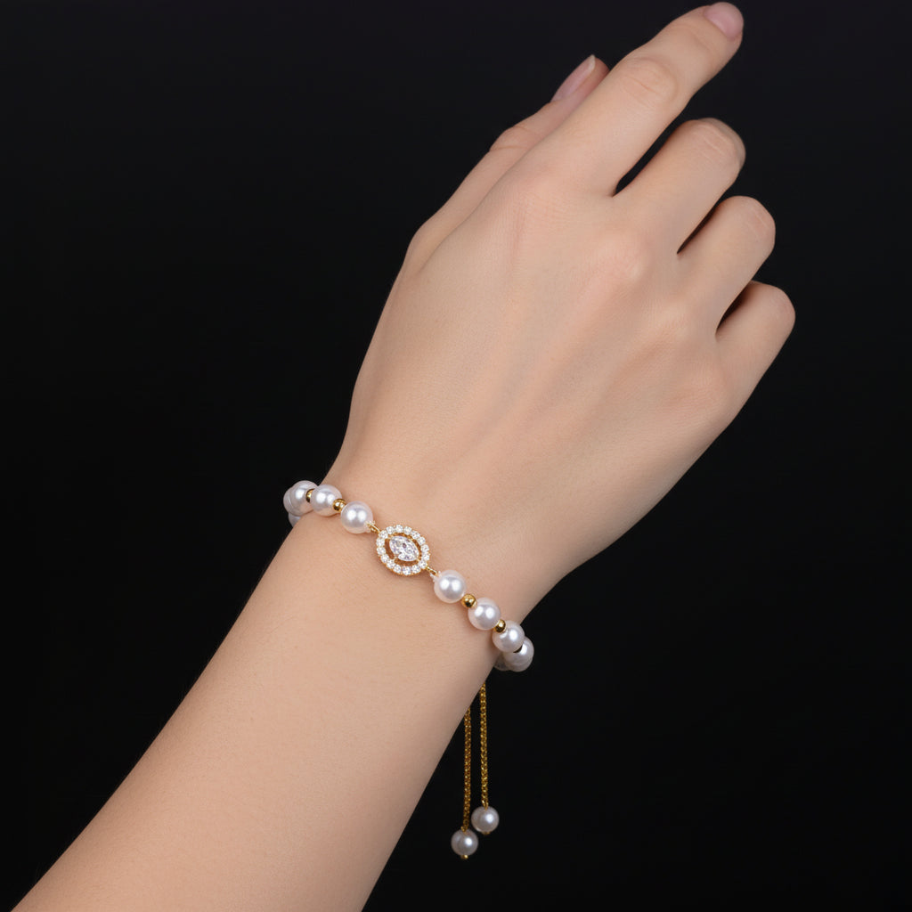 Pearl earring with gold accents on a black background, branded 'Saheli'.