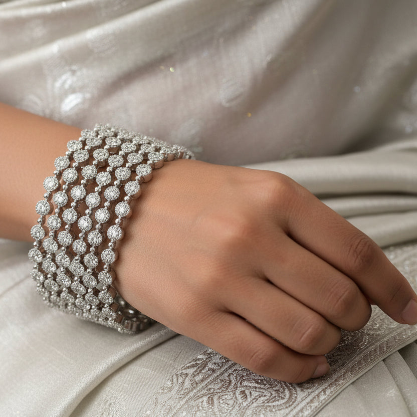 Silver bracelet on a black stand with 'SAHELI' branding in the background