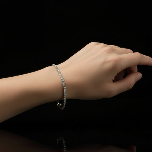 Silver bracelet with clear stones on a black background