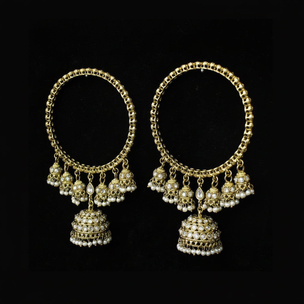 Pair of gold hoop earrings with dangling beads on a black background
