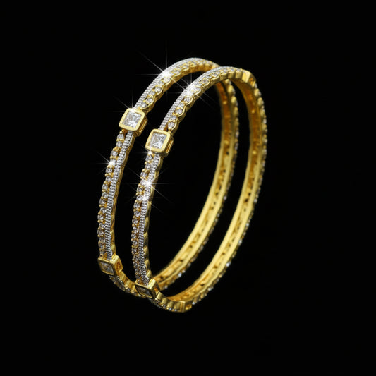 Gold bangles with gemstones on a black background, branded 'Saheli'.