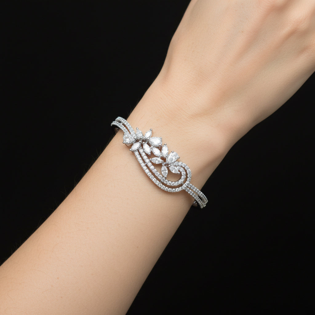 Silver bracelet with diamond-like stones on a gray surface