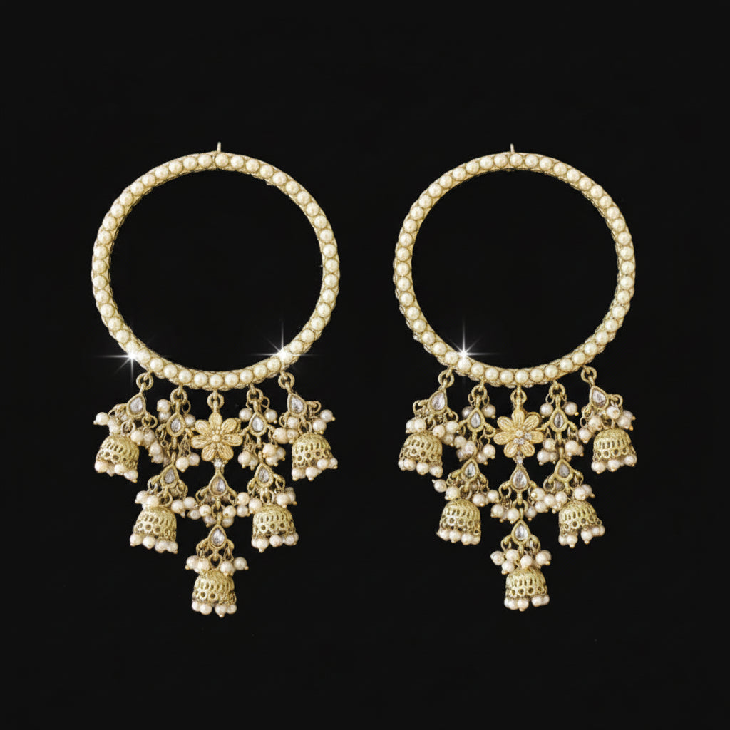 Pair of gold chokers with floral pendants on a black background