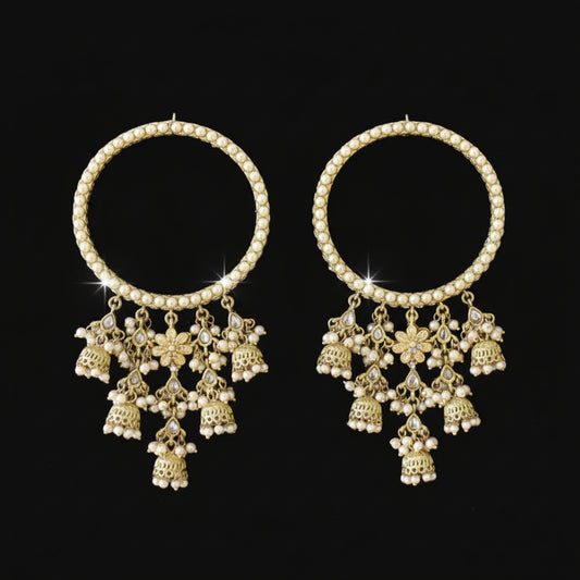 Pair of gold chokers with floral pendants on a black background