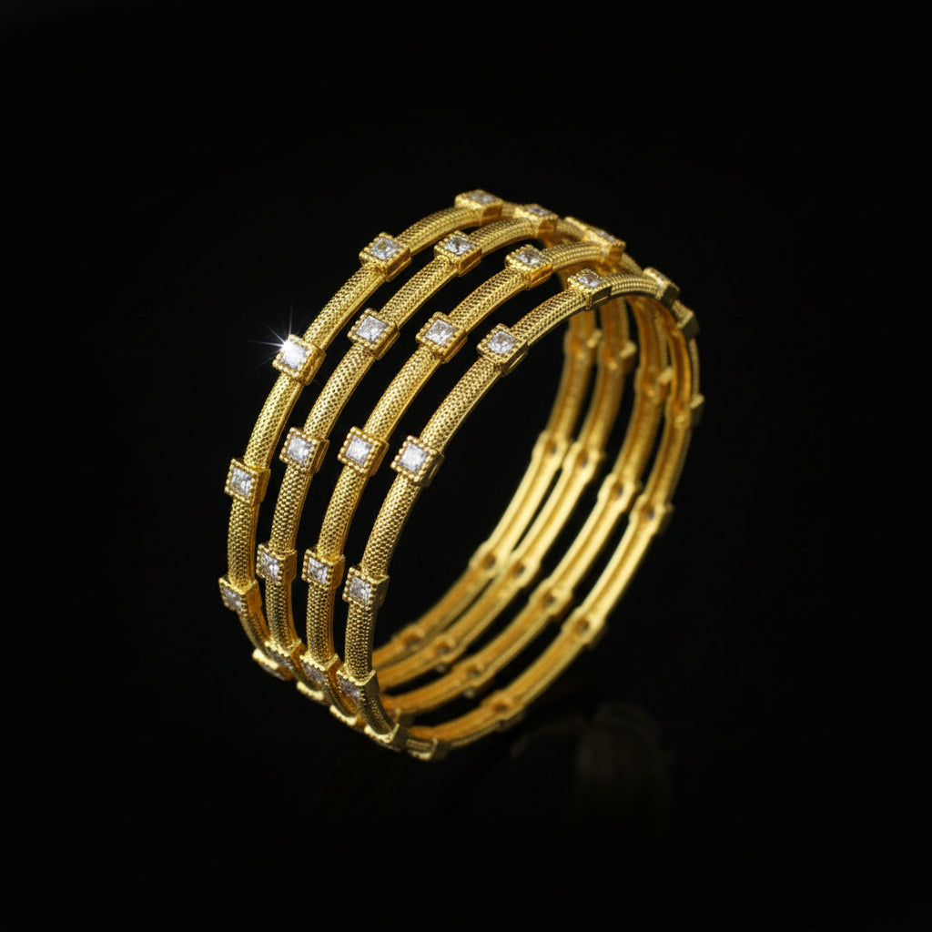 Gold bangles with embedded stones on a black stand, branded 'SAHELL'.