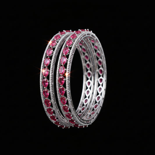 Pair of pink gemstone hoop earrings on a black background with 'SAHELI' brand logo.
