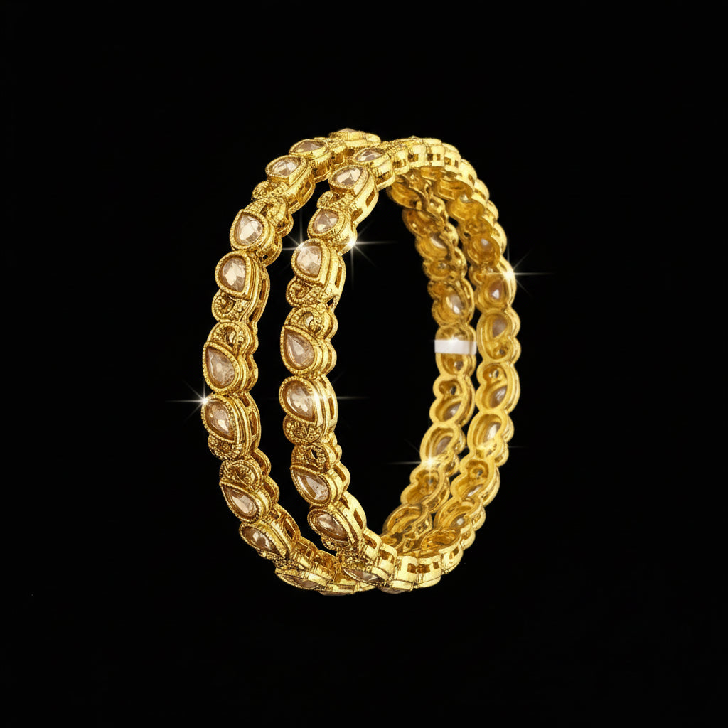 Gold bangles on a gray stand with 'Saheli' branding.