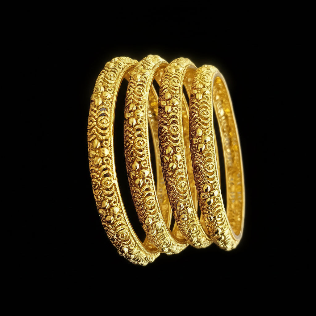 Three gold bangles with intricate designs on a gray background, featuring the brand 'Saheeli'.