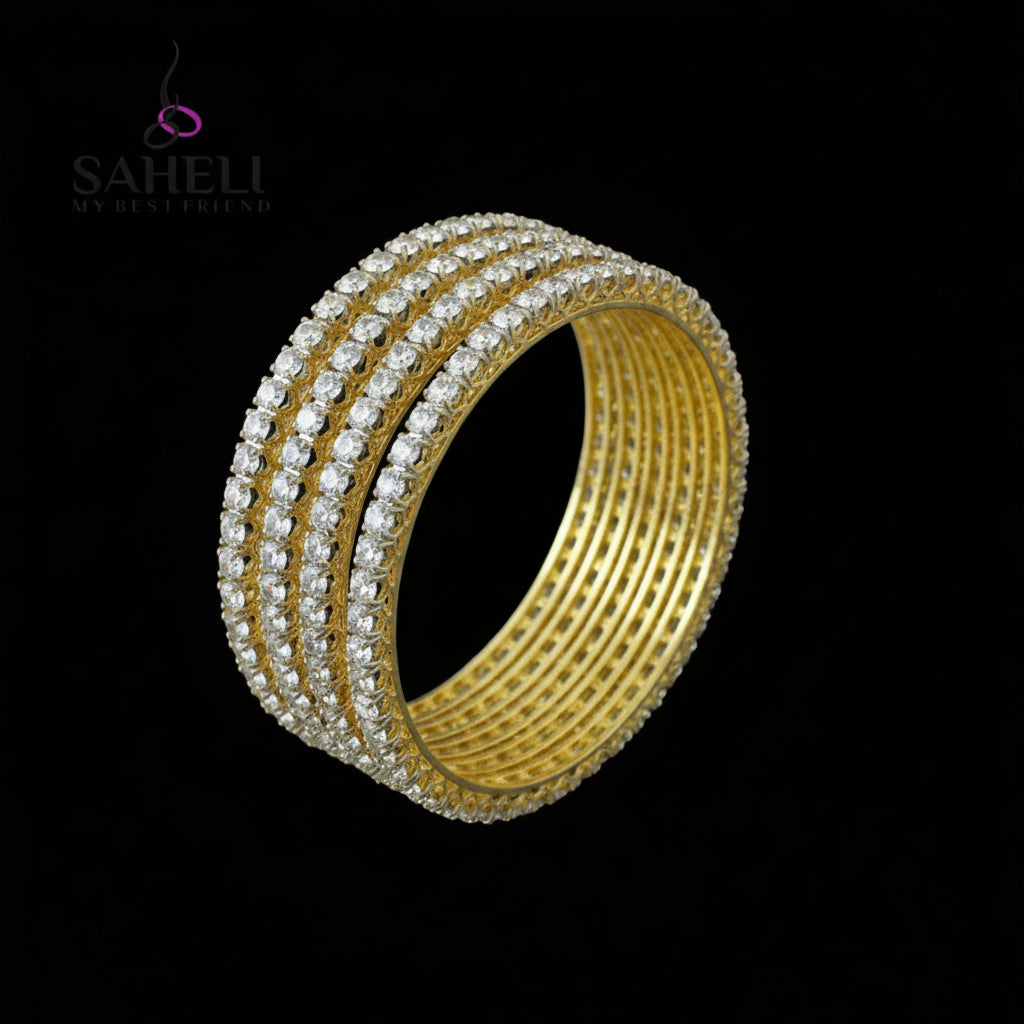 Set of gold and pearl bangles on a black stand with 'SAHELI' branding.
