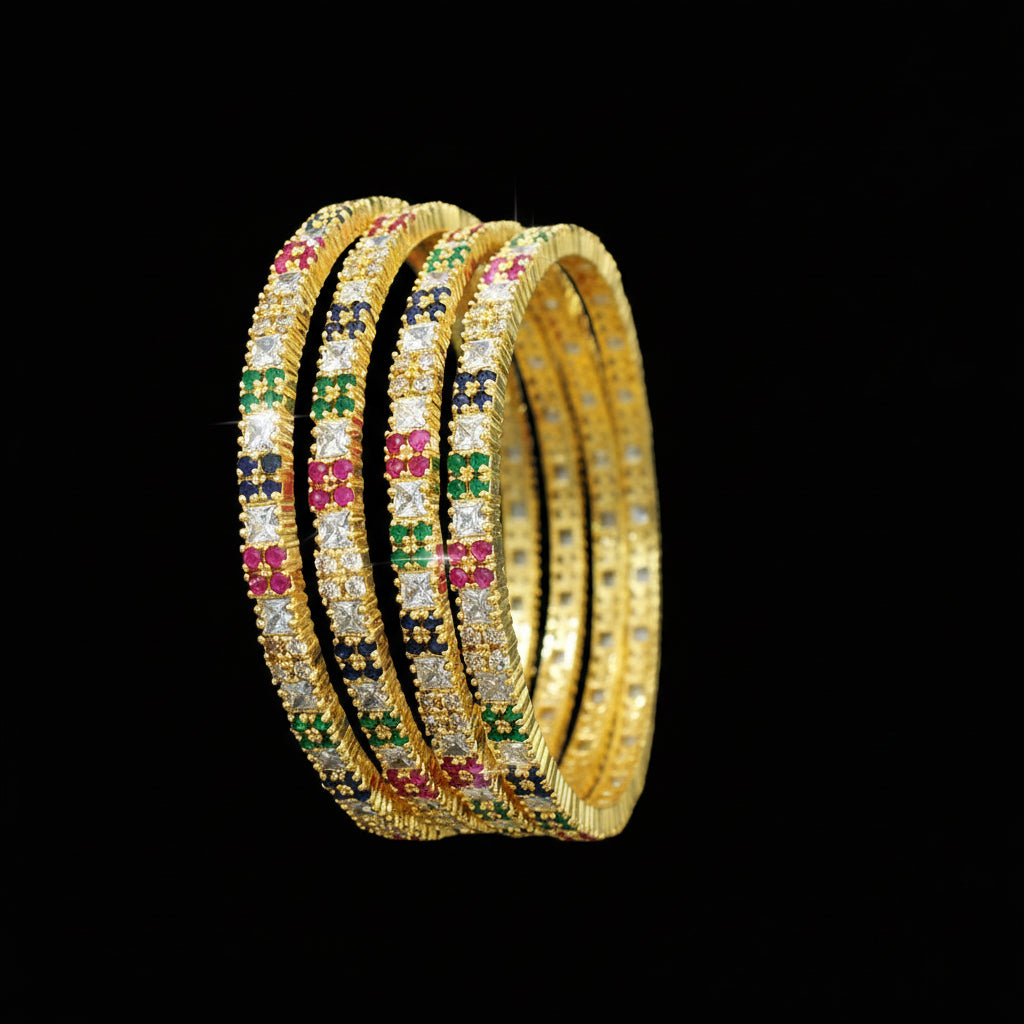 Gold bangles with colorful stones on a dark background, branded 'Saheli'.