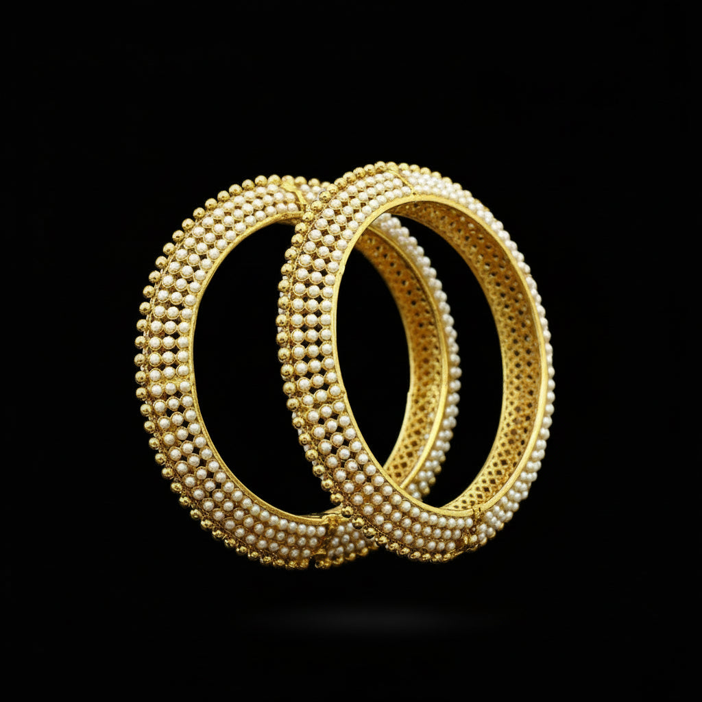 Gold bangles on a black stand with 'SAHELI' branding.