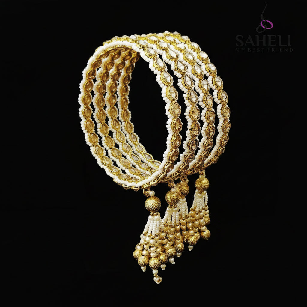 Gold and white jewelry set on a black stand with 'SAHELI' branding.