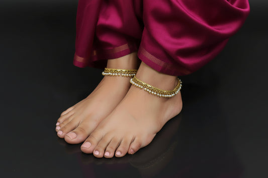 Gold necklace with pearls on a dark background