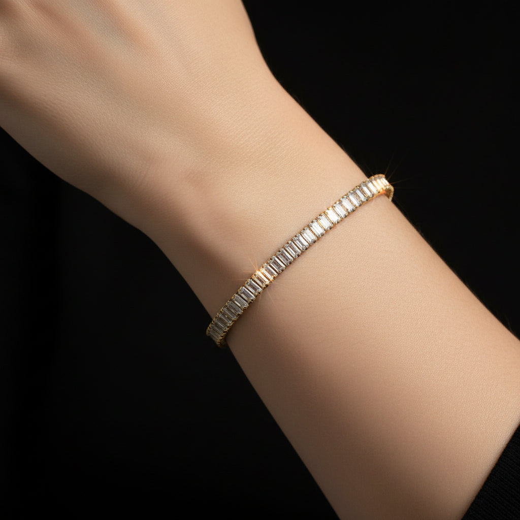 Gold bracelet with diamond accents on a dark reflective surface