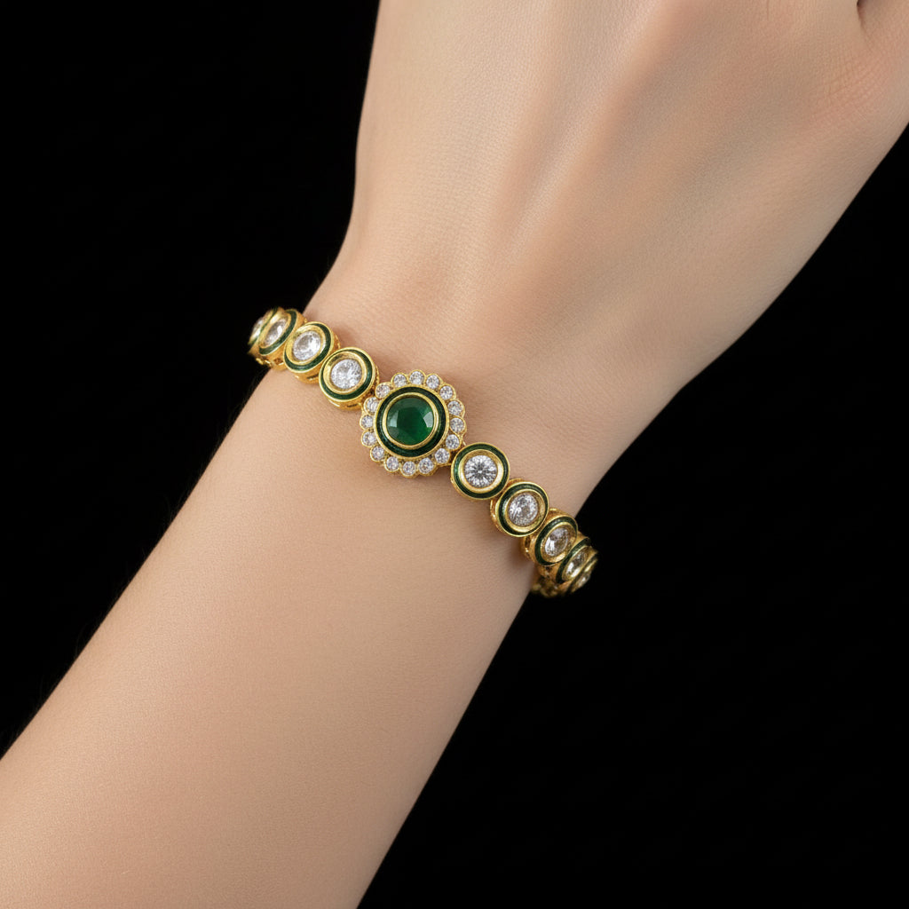 Gold bracelet with green gemstone on a dark background, branded 'Saheli'.