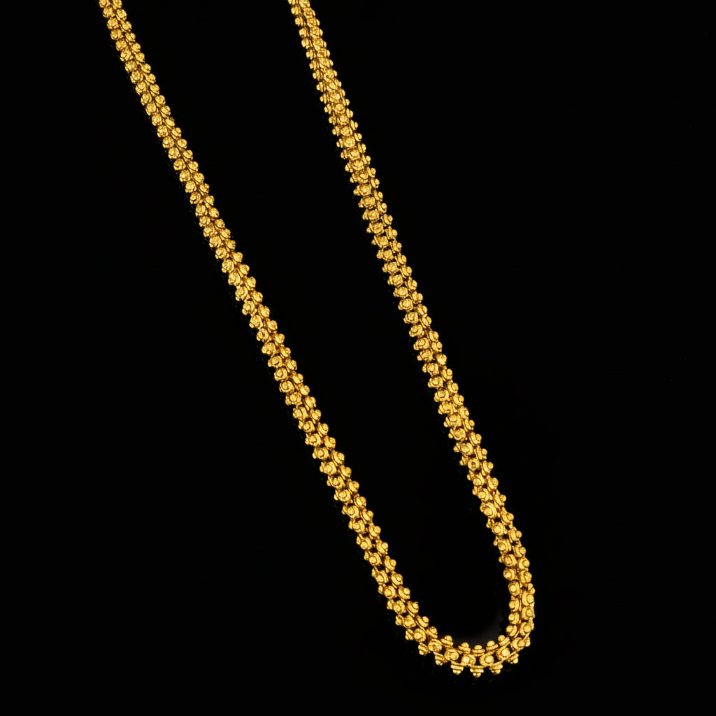 Gold necklace on a gray background with 'SAHELI' branding.