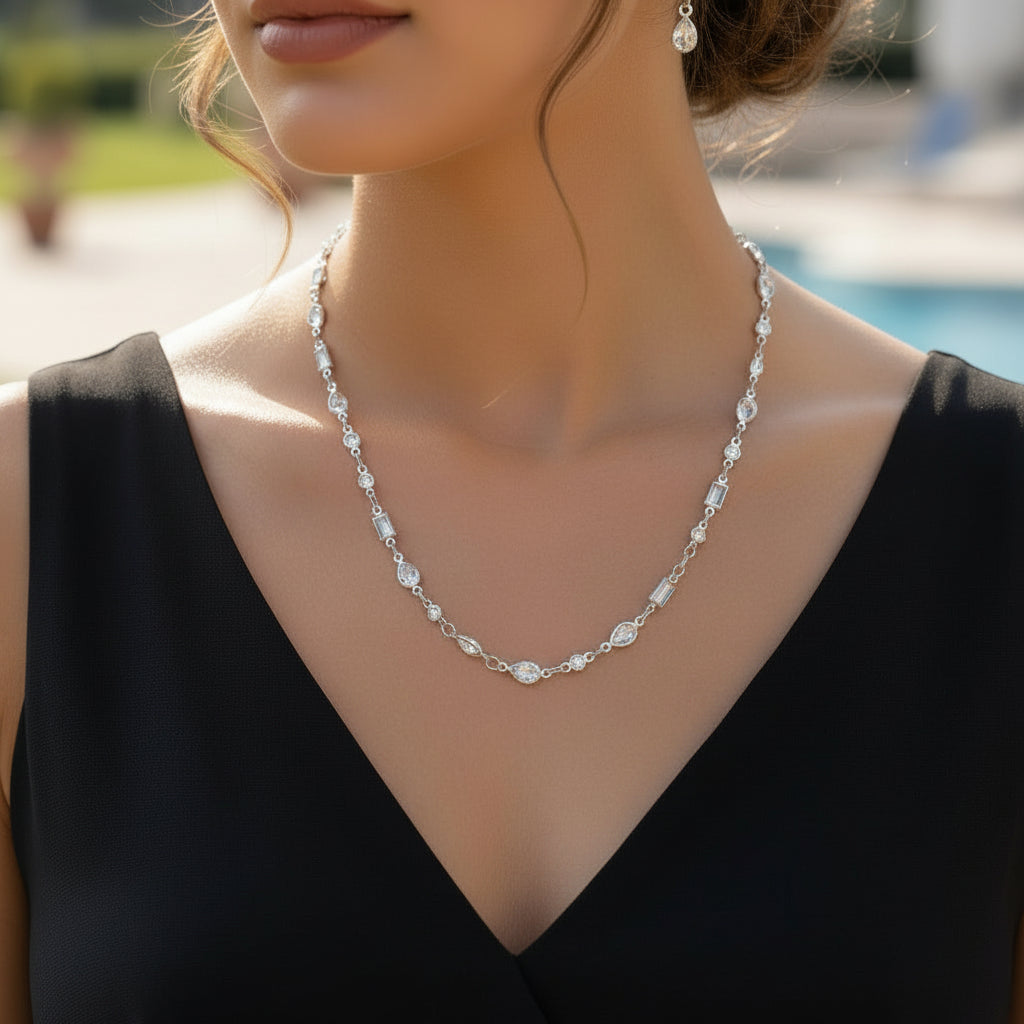 Silver necklace on a black mannequin with 'SAHELI' branding.