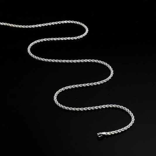 Silver chain necklace on a dark gray background