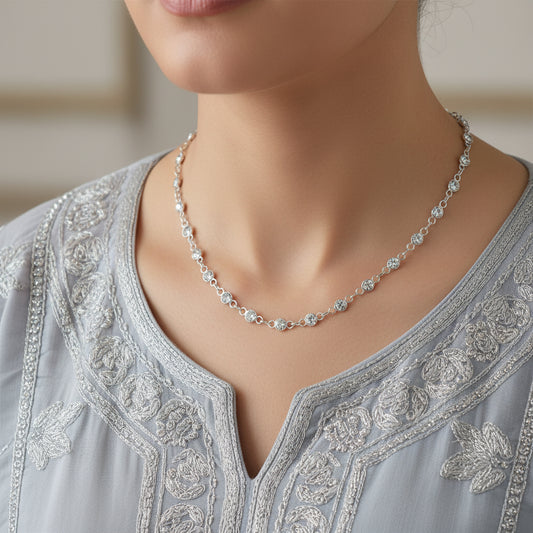 Silver chain necklace on a gray background