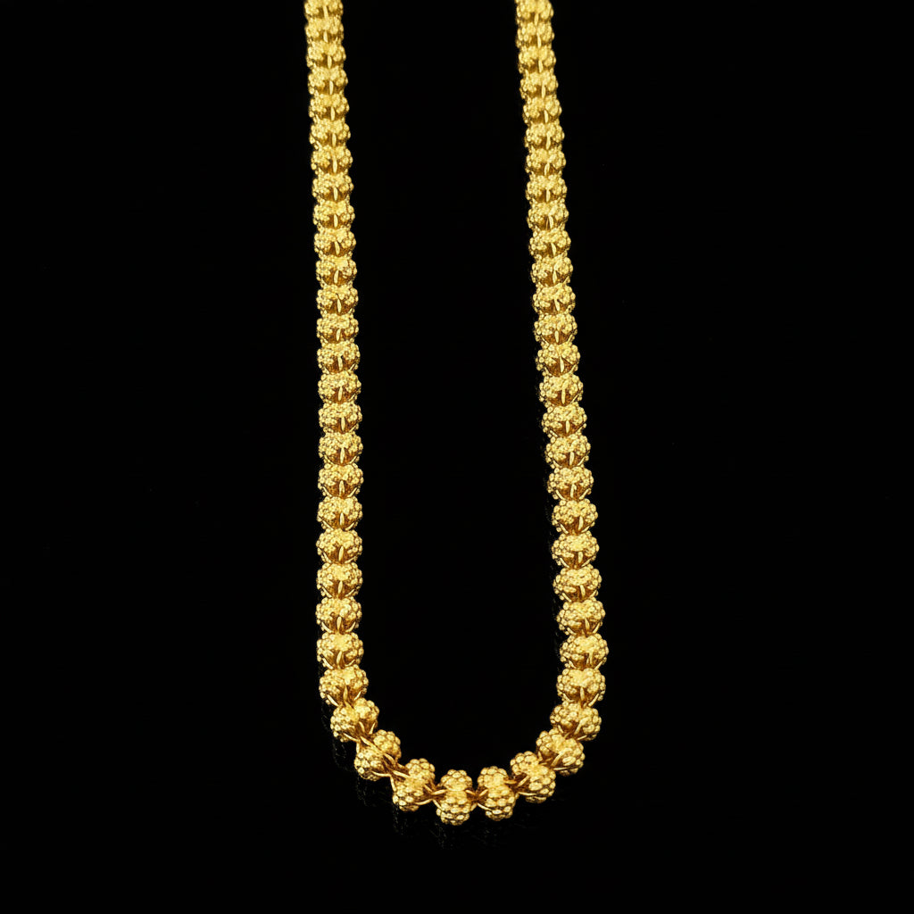 Gold chain necklace on a gray background with 'SAHELI' branding.