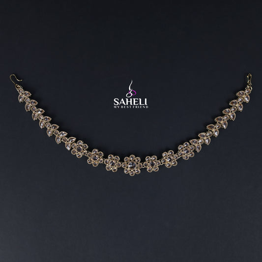 Delicate silver necklace on a dark background with 'SAHELI' branding.