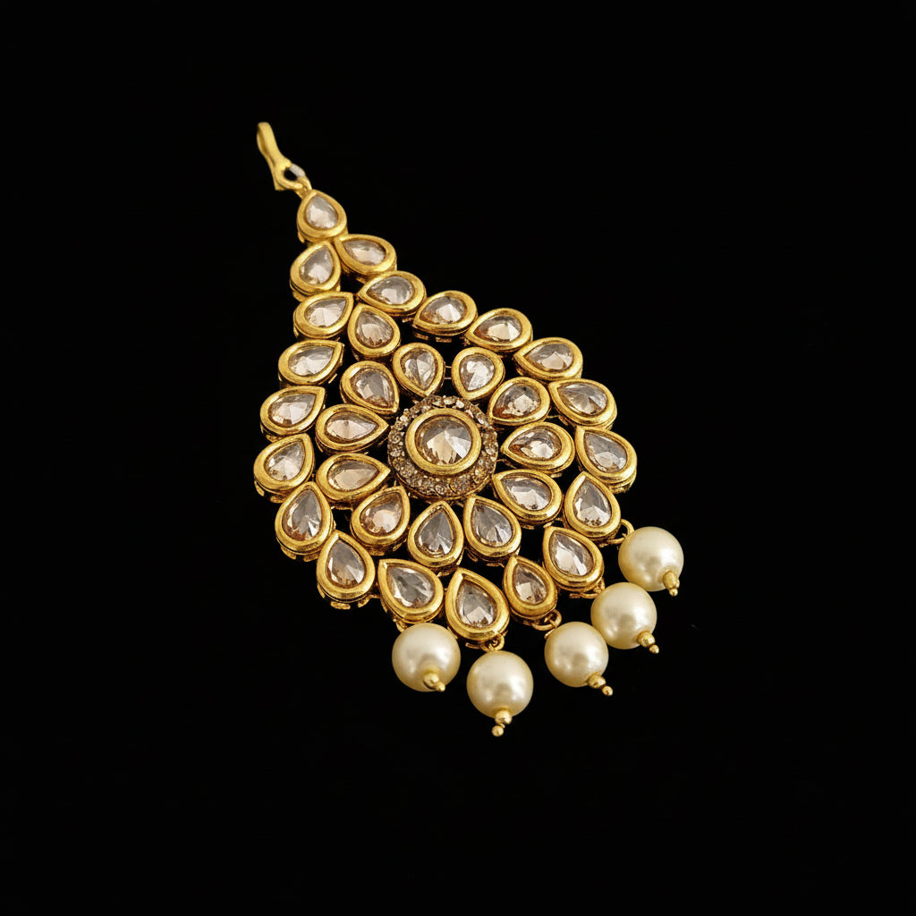 Gold and pearl pendant on a dark background with 'SAHELI' branding.