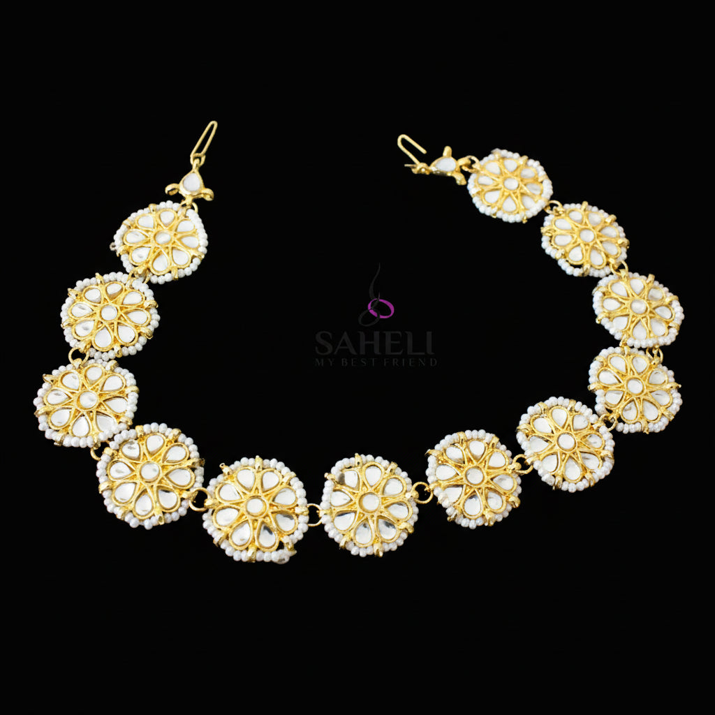 Gold and pearl necklace with matching earrings on a dark background, featuring the brand 'Saheli'.