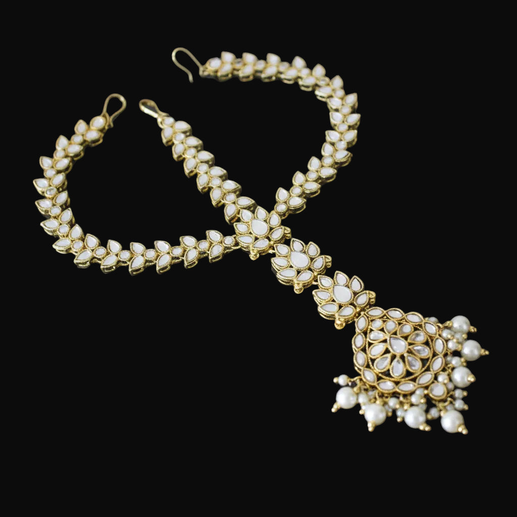 Jewelry set with necklace, earrings, and bracelet on a dark background with 'Saheli' branding.