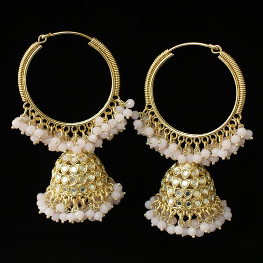 Pair of gold hoop earrings with white beads on a black background