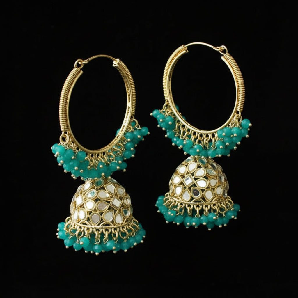 Pair of gold and turquoise earrings on a black stand