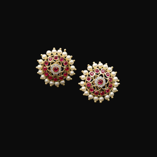 Jewelry earrings with red and white stones on a black background, featuring the brand 'Saheli'.