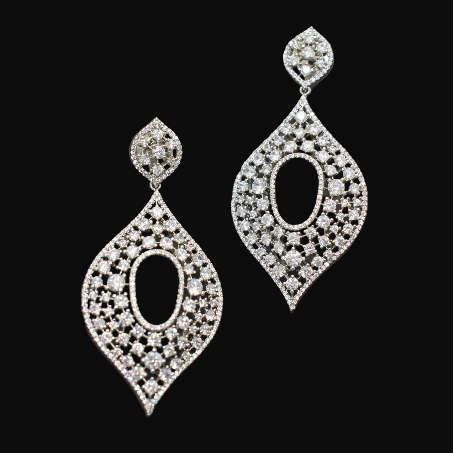 Pair of diamond earrings on a dark gray background