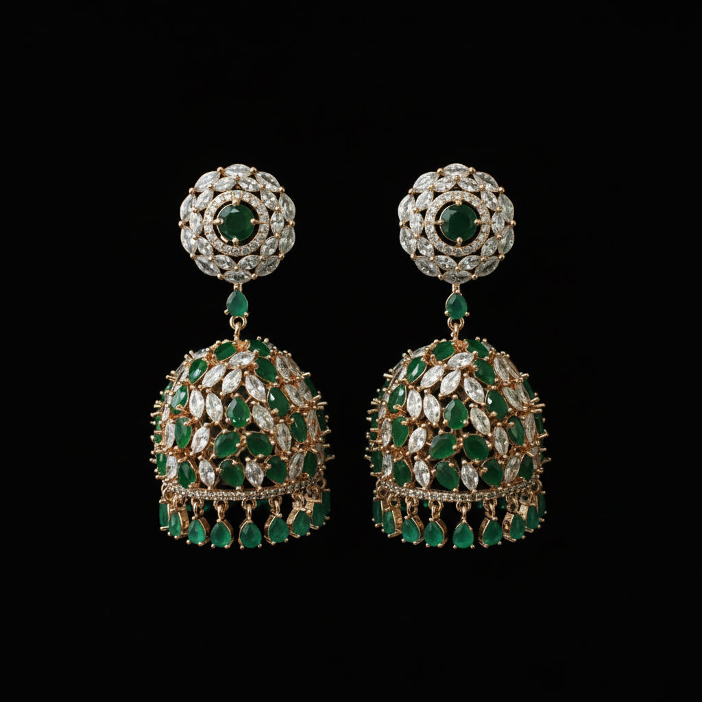 Pair of emerald and diamond earrings on a black stand