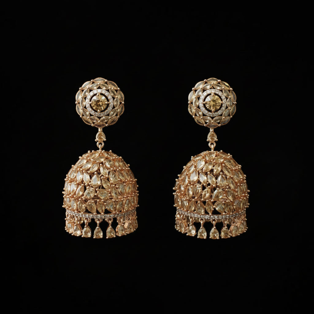 Pair of gold earrings with intricate designs on a black stand.