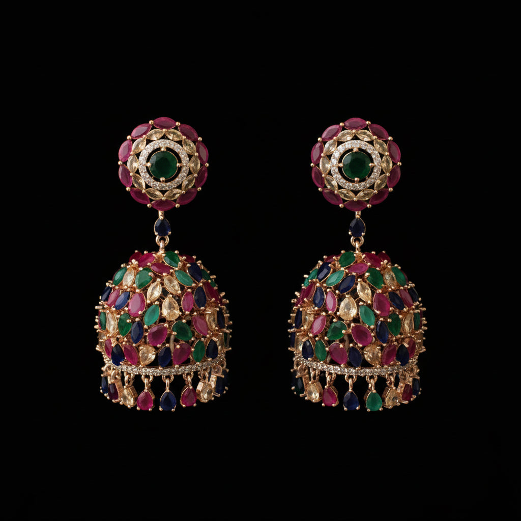 Pair of ornate earrings with gemstones on a black background