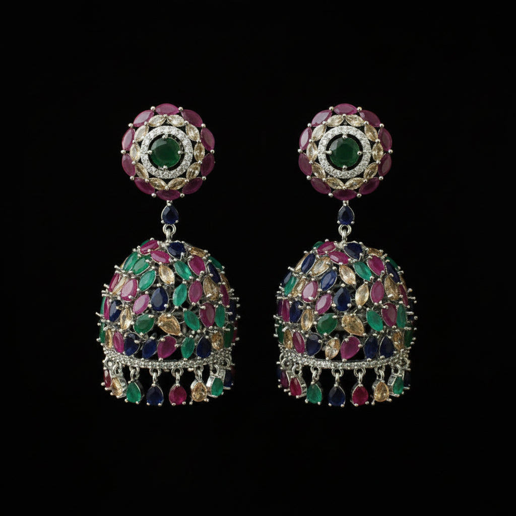 Multicolored gemstone earrings on a black stand against a black background