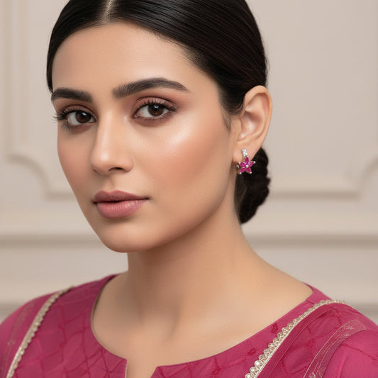 Silver earrings with pink flowers on a gray background, featuring the brand 'Saheli'.