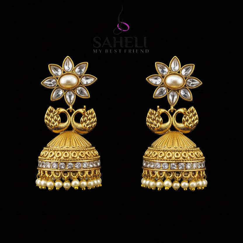 Gold earrings with floral design on a gray stand, branded 'Sahello'.